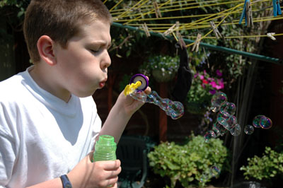Boy blowing bubbles Boy blowing bubbles